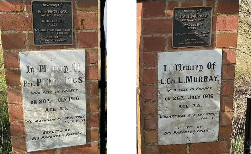 Commemorative plaques on the gates to the cemetery