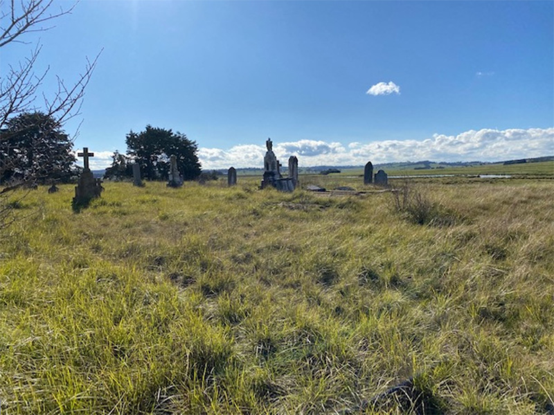 The weed strewn Breadalbane Graveyard with old gaves shown