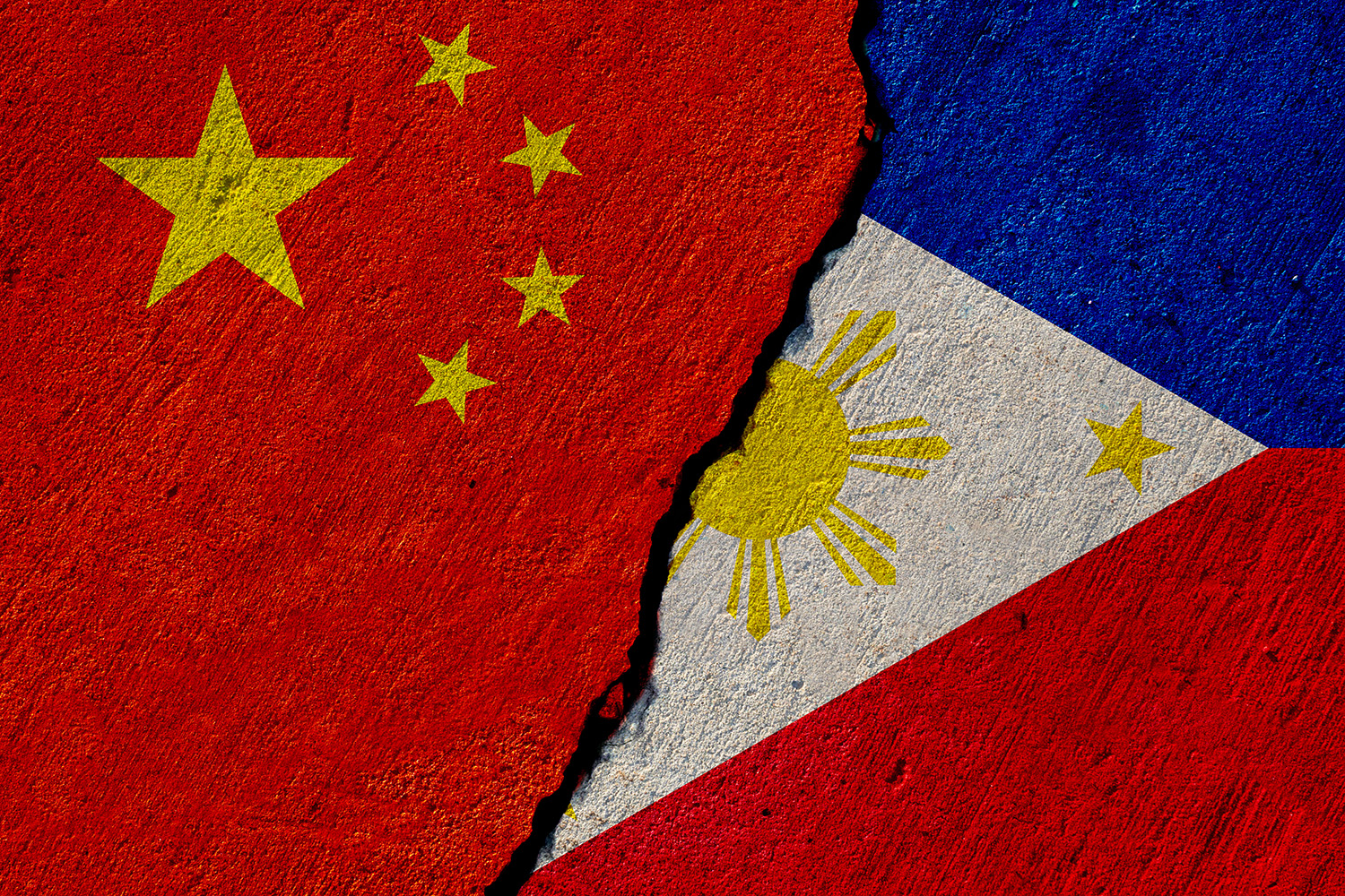 China and pillipine flages painted on a contrete wall, the ragged line between then indicating conflict