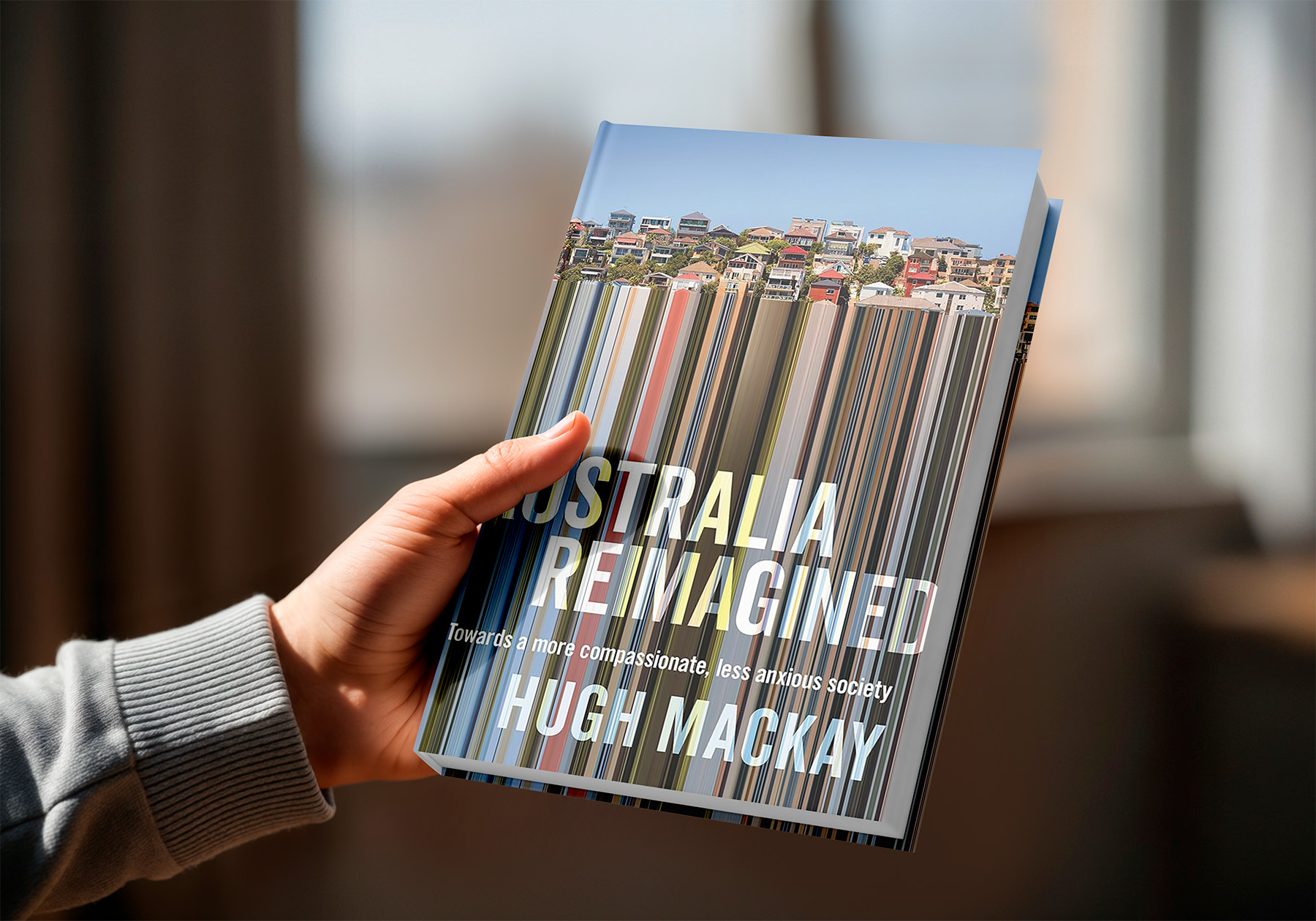 Hand holding the Book Australia Reimagined