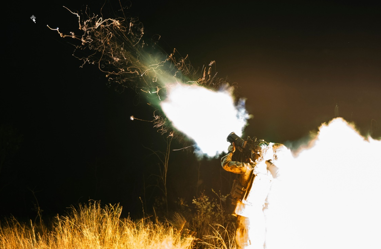 Soldier with a rocket launcher, photo is taken just after fring of th elauncher with flames venting from the tube