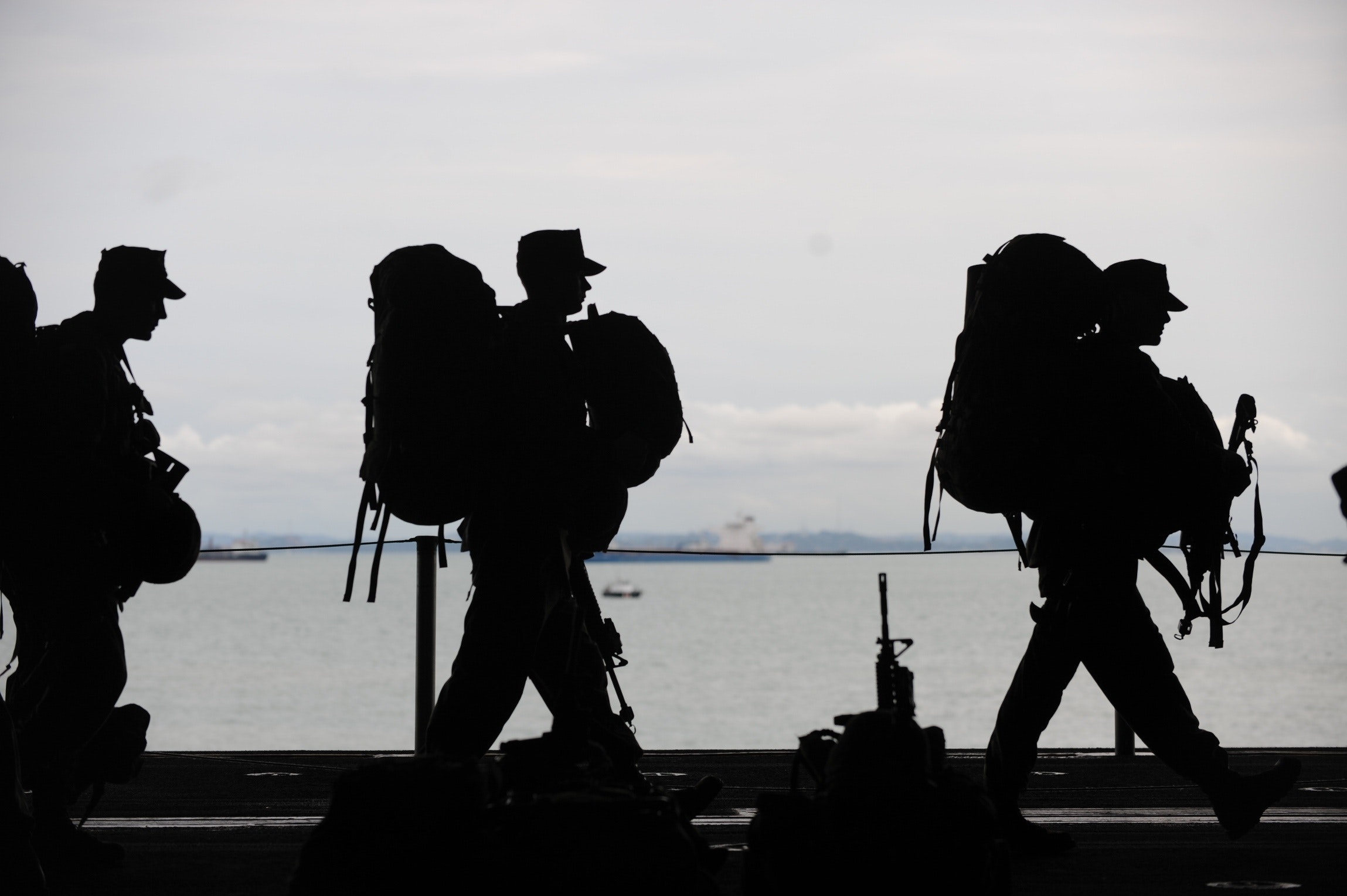 Military campaign Military personnel walking in single file, silhouette