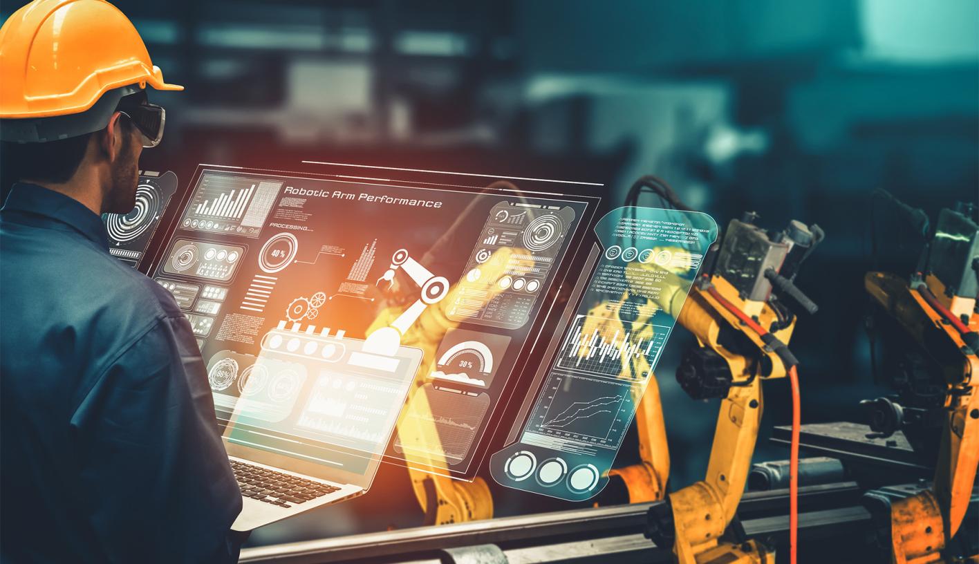 Manufacturing Worker at a futurist holographic terminal controling a robot production line.