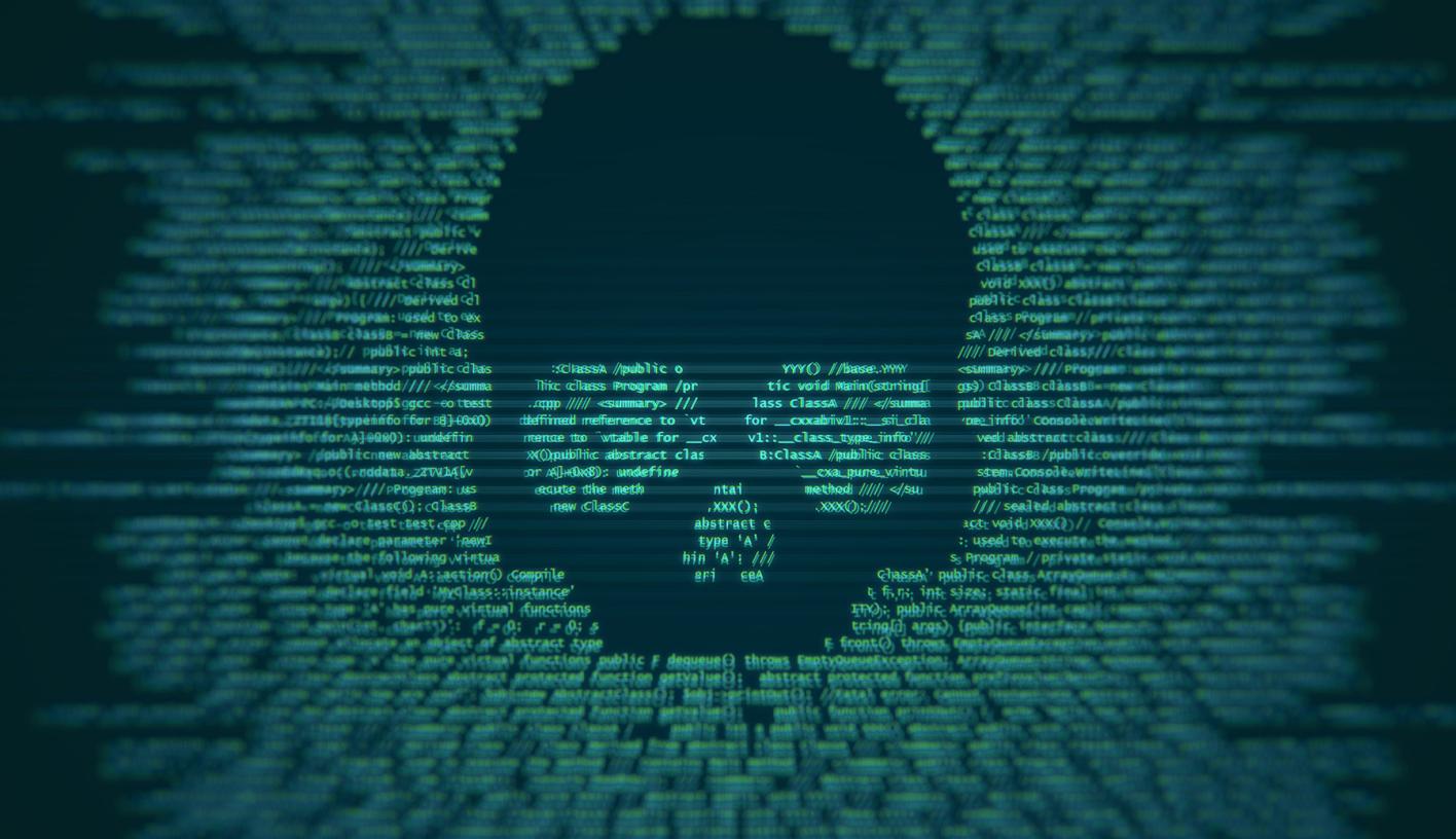 A threatening skull embedded into code on a cimputer screen.