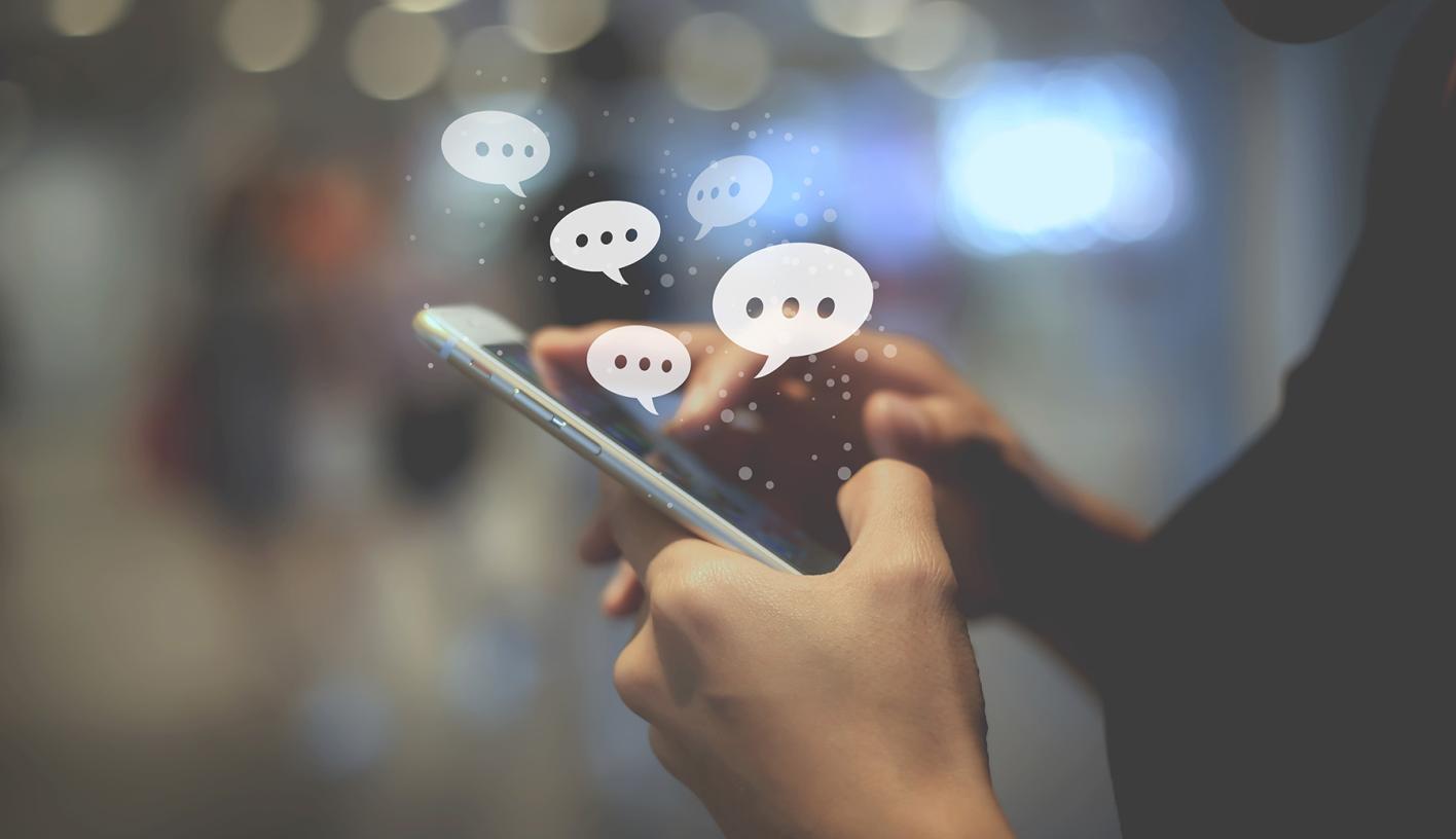A person entering a comment on a mobile device.