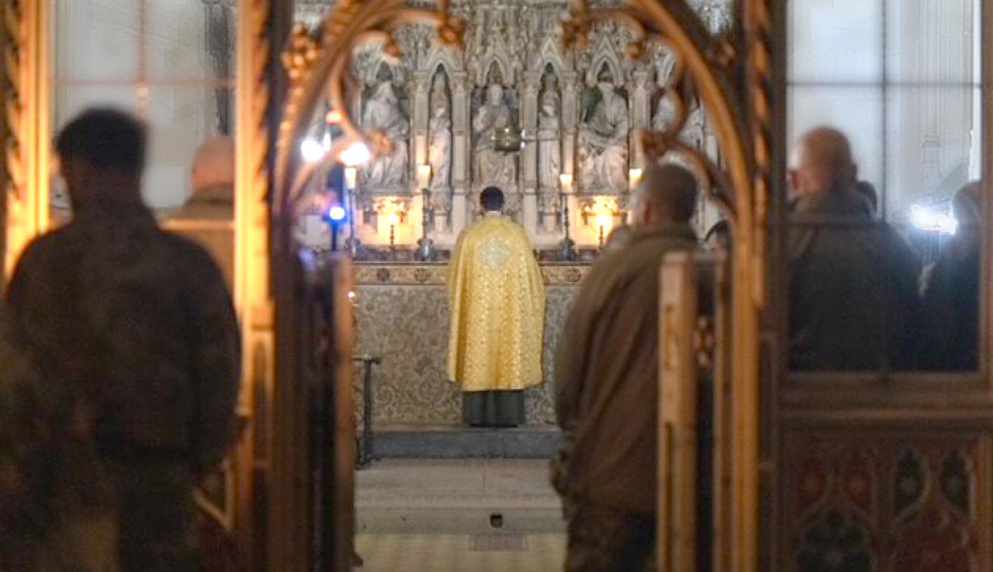 Evening Prayer, A priest stand facing the alter with uniformed soldiers in the congregation