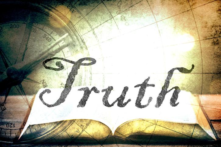 The word truth floating over a glowing book with a compass in the background