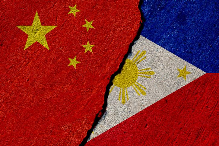 China and pillipine flages painted on a contrete wall, the ragged line between then indicating conflict