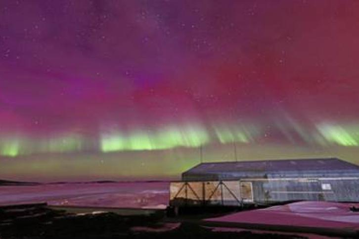 Antarctica with the Southern lights showing in the sky
