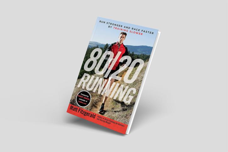 The book cover for 80/20 Running featuring the author running along a dirt track in the wilderness