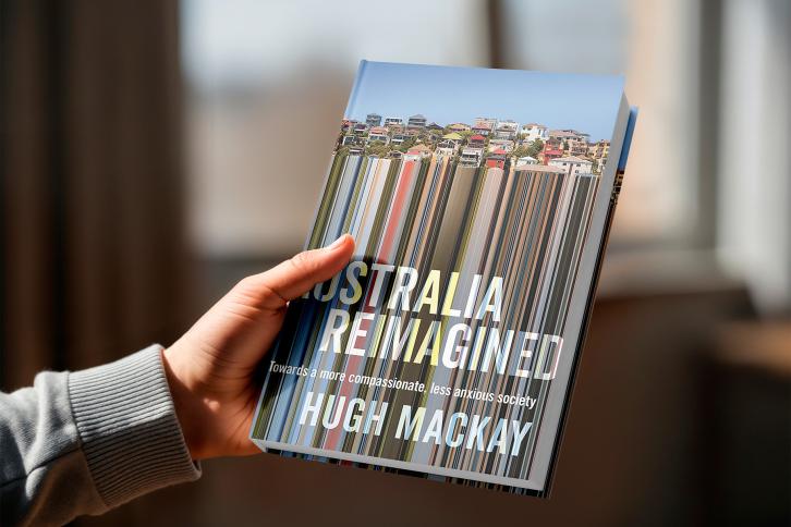 Hand holding the Book Australia Reimagined