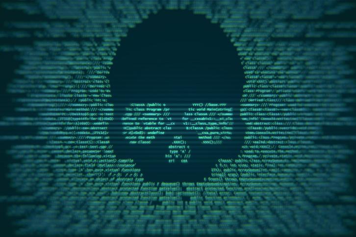 A threatening skull embedded into code on a cimputer screen.