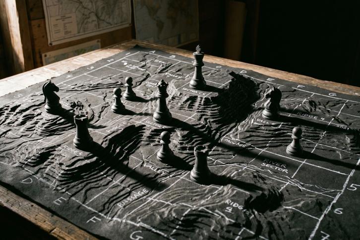 A topological map with chess pieces strategically placed.