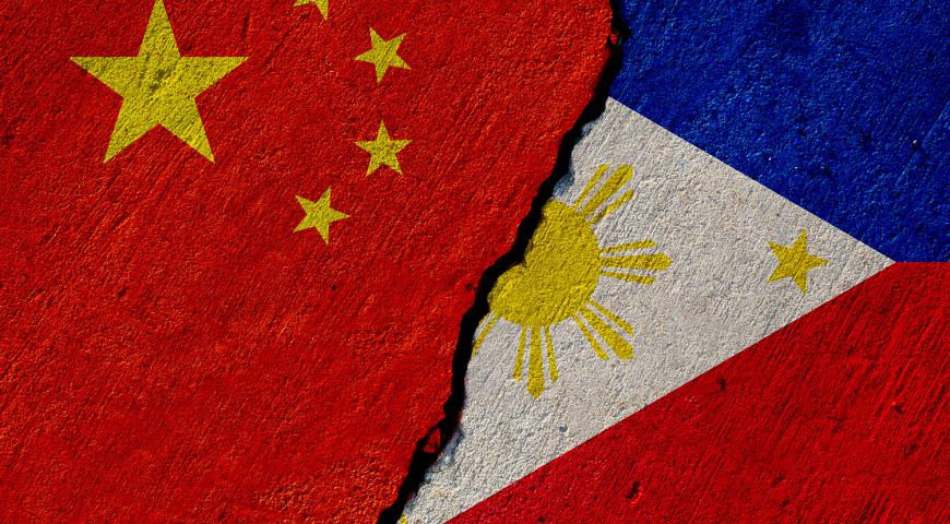 China and pillipine flages painted on a contrete wall, the ragged line between then indicating conflict