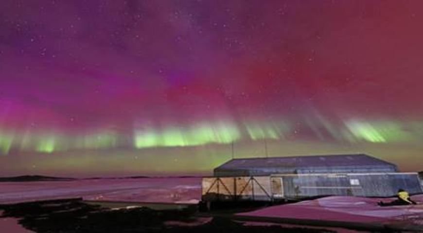 Antarctica with the Southern lights showing in the sky