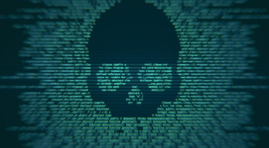 A threatening skull embedded into code on a cimputer screen.