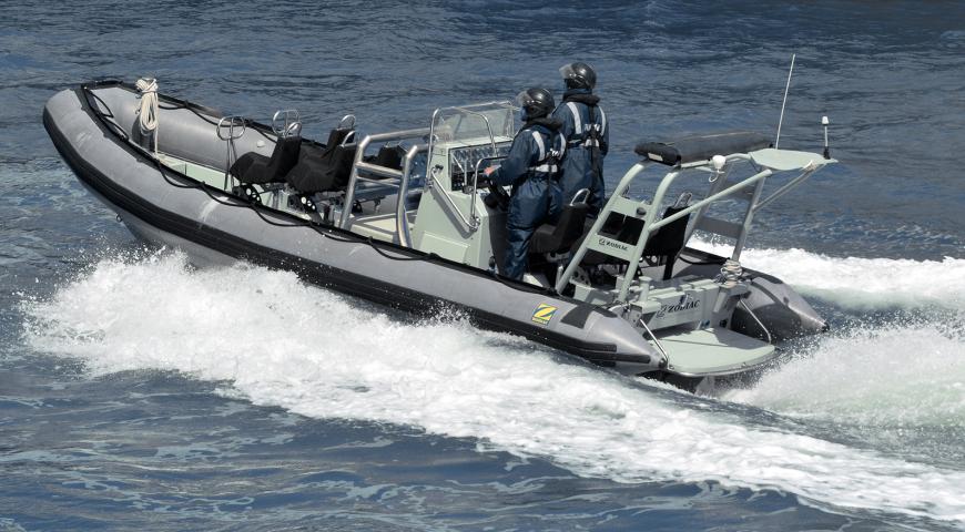 Royal New Zealand navy sailors ride a Zodiak Rigid-hulled inflat