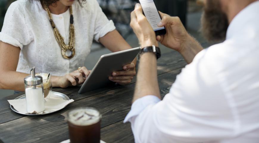 People using phones at a cafe