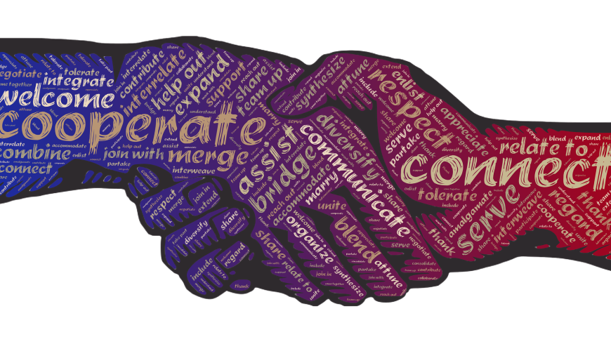 Hands shaking with the words cooperate and connect written on them