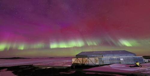 Antarctica with the Southern lights showing in the sky
