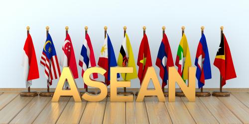 The flags of the countries in the Association of Southeast Asian nations with the word ASEAN in gold 3D letters in the foreground.