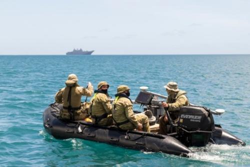 RAN personnel in a small outboard motor boat